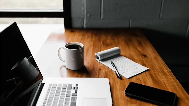 Coffee and Laptop on Wooden Desk