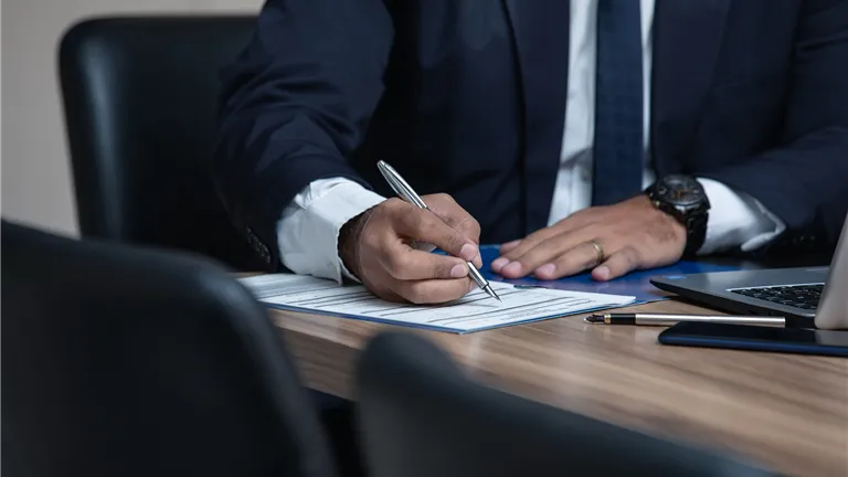 Lawyer Writing on Notepad