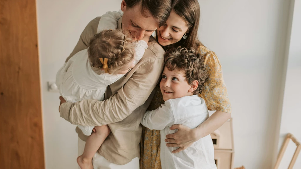 A heartwarming scene of a family hugging indoors, showcasing love and togetherness.